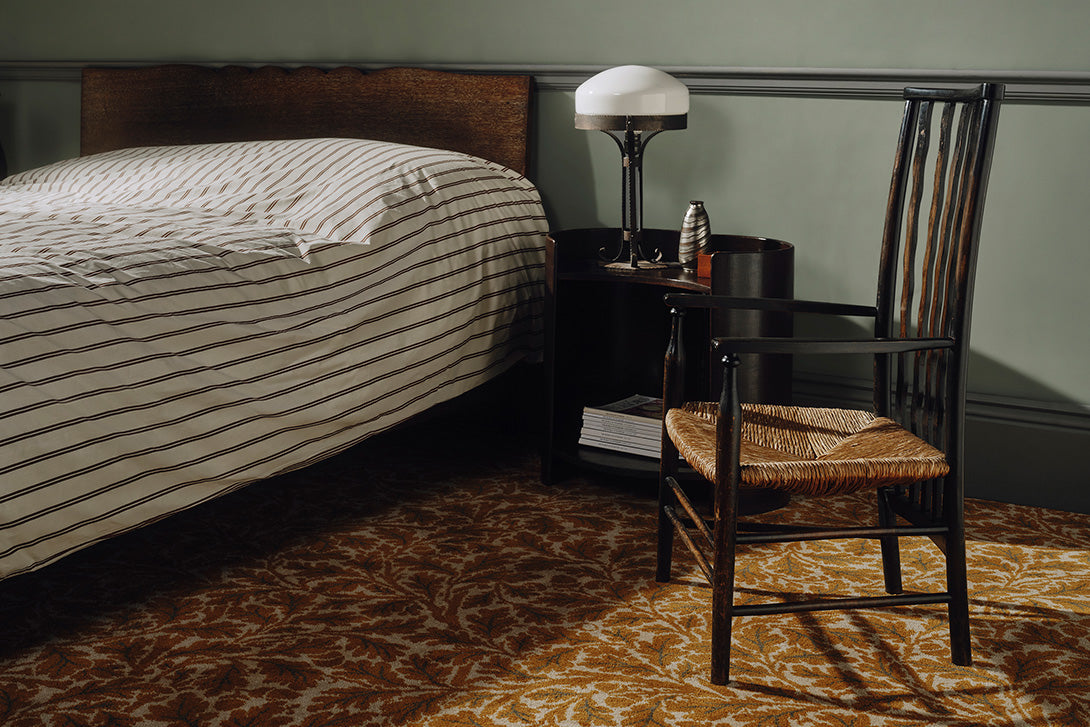 a chair next to a bed