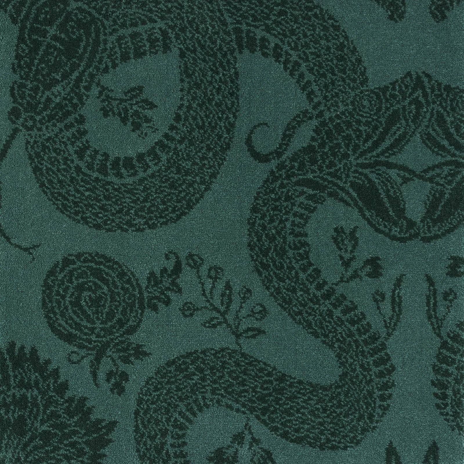 a green patterned carpet with a snake and flowers