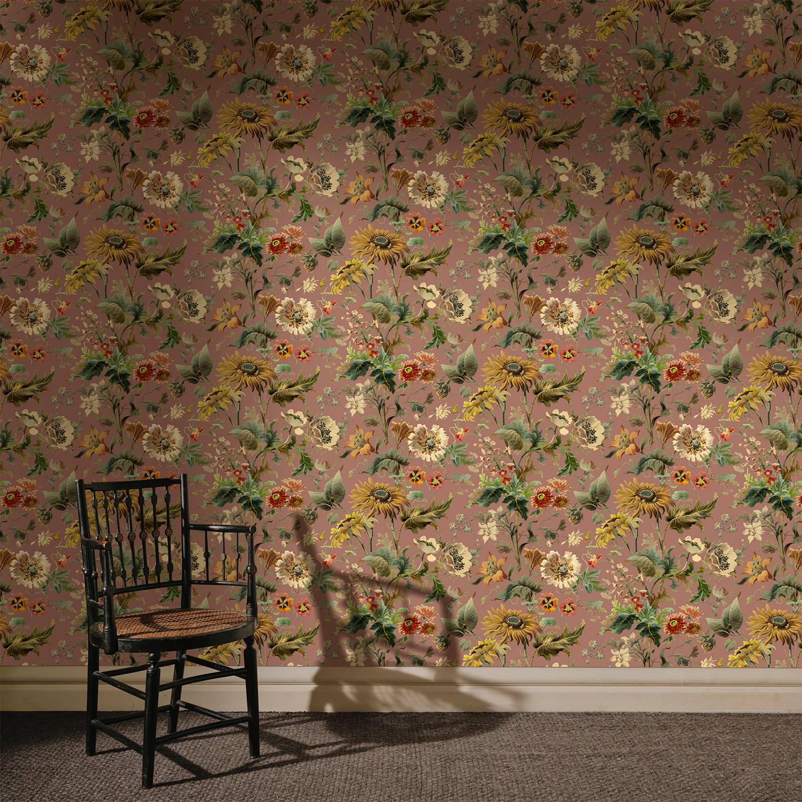 a chair in front of a wall with floral wallpaper