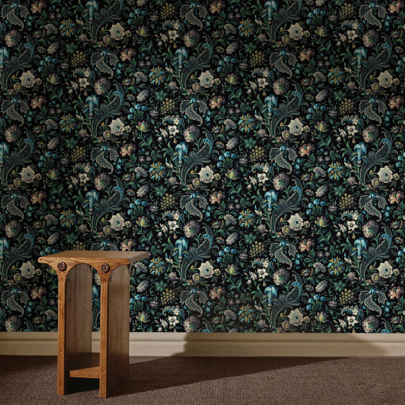 a wooden table in a room with floral wallpaper